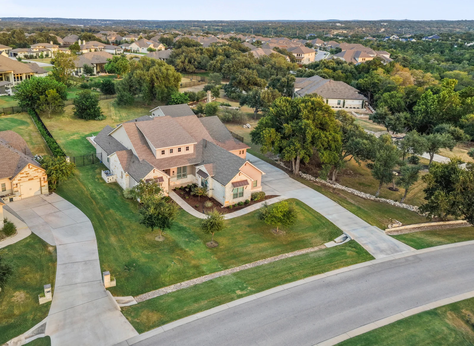 Aerial view of the front of 649 Bunker Ranch Blvd, its driveway and surrounding live oaks