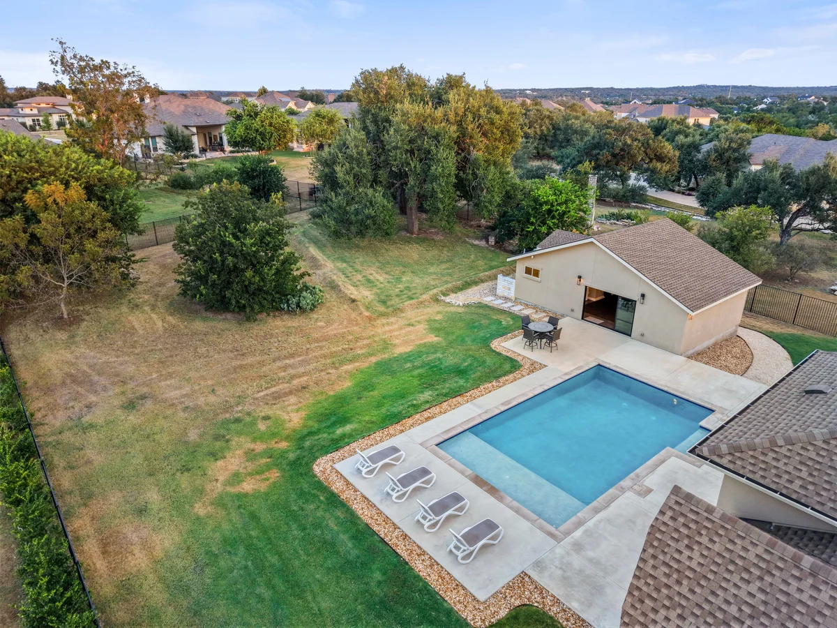 Aerial view of the private pool, detached casita and tree-lined backyard